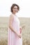 Enjoying the nature. Woman stay in wheat field and holding wheats