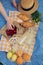 Enjoying a picnic: croissants, strawberries, lemonade on checkered blanket