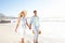 Enjoying the refreshing breeze on the beach. A blissful couple enjoying a beautiful day on the beach together.