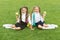 Enjoying snack break. Happy girls eat apples on green grass. Taking vitamin snack. School snack. Healthy eating and