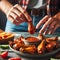 Enjoying Spicy Chicken Wings With Dipping Sauce at a Casual Evening Gathering