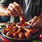 Enjoying Spicy Chicken Wings With Dipping Sauce at a Casual Evening Gathering