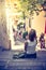 Enjoying the summer holiday: Young girl is sitting on the stony stairs and resting