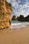 Enjoying summer holidays in seascape view with stunning seas caves on sandy camilo beach, algarve, portugal