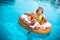 Enjoying suntan Woman in bikini on the inflatable mattress in the swimming pool