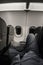 Enjoying three seats on a plane`s economy cabin