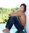 Enjoying the tranquility of solitude. Portrait of a handsome young man sitting against a wall at home.