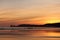 Enjoying view just before sunrise of silhouette deux jumeaux in colorful summer sky on a sandy beach