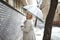 Enjoying a walk in the rain. a young woman walking down the street with an umbrella on a rainy day.