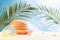Enjoyment summertime beach vacation - picnic on tropical beach with fun beach games - slinky toy, sun hat, seashells under palm.