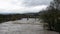 The enlarged Piave river passes through Belluno under an intense rain