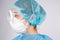Enlarged profile photo. Doctor in a protective mask and medical goggles on gray background