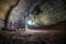 Enlighted lava tunnel with humid floor in the Galapagos island of Sand Cruz on the way to Puerto Ayora, Ecuador