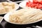 Enokitake mushroom with tofu and sliced tomato on white plate