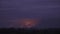 Enormous explosion with sparks, reflected in the purple sky, aerial shot