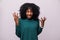 Enraged young curly african woman with hands up yelling isolated on white background