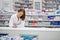 Ensuring every prescription is correct. Shot of an attractive young pharmacist working at the prescription counter.