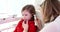 ENT doctor examines child ear with otoscope