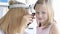 Ent with frontal reflector examining little girl ear with otoscope 4k movie