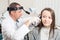 ENT physician looking into patient`s ear with an instrument. private clinic. otolaryngologist