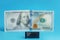 Enter button in the foreground blurred banknote one hundred dollars centered on a turquoise background