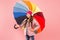 Entertain yourself. Fun concept. Feeling good. Girl having fun walking wireless headphones under colorful umbrella. Fall