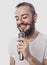 The entertainer. Young talking man holding microphone, Isolated on white background.