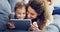 Entertainment sorted for their mommy daughter bonding session. a cute little girl using a digital tablet with her mother