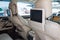 Entertainment system for rear passengers in a car with two monitors mounted on the backs of the front seats for watching TV,