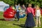 Entertainment of zorbing in the park. Children rolling downhill inside an orb sphere. Enjoy of childhood.