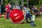 Entertainment of zorbing in the park. Children rolling downhill inside an orb sphere. Enjoy of childhood.