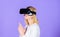 Enthralling interaction virtual reality. Woman head mounted display violet background. Virtual reality shooting gallery