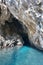 Enthralling sea cave in the calcareous cliff outcropping on an aquamarine sea.