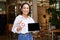 Enthusiastic asian woman shows okay sign, tablet screen, looks impressed, recommends smth