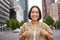 Enthusiastic asian woman , shows thumbs up in approval, looking upbeat, say yes, approves and agrees, stands on street