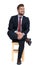 Enthusiastic businessman sitting on wooden chair and looking up