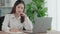 Enthusiastic businesswoman working and typing laptop in the office.