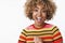 Enthusiastic and excited african-american cute girl in stylish striped sweater smiling broadly open mouth from thrill