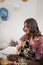 Enthusiastic female playing guitar enjoying art hobby boho scandi home party singing song relaxing