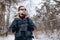 Enthusiastic Hiker in Anorak and Mirrored Glasses in Snow-clad Forest