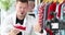 Enthusiastic male blogger demonstrates red sneakers to camera 4k movie