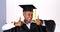 Enthusiastic mature black woman in graduation gown