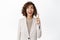 Enthusiastic saleswoman, business woman pointing finger up and looking at top company advertisement, banner upwards