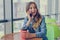 Enthusiastic smiling happy woman sitting in a cafe holding cup of coffee, she is talking on phone with friend, talk, cell, phone,