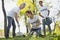 Enthusiastic three volunteers pouring in tree