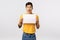 Enthusiastic, thrilled handsome chinese guy with tattoos, holding sign, blank piece paper over chest, promote company