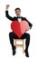 Enthusiastic young groom holding big red heart