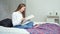 Enthusiastically young girl reading interesting book at cozy bedroom at home