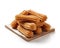 Enticing fresh churros on a wooden plate white background, Generative AI