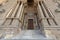 Entrance of al Rifai Mosque with closed decorated wooden doors, ornate columns, stone wall and stairs, Old Cairo, Egypt